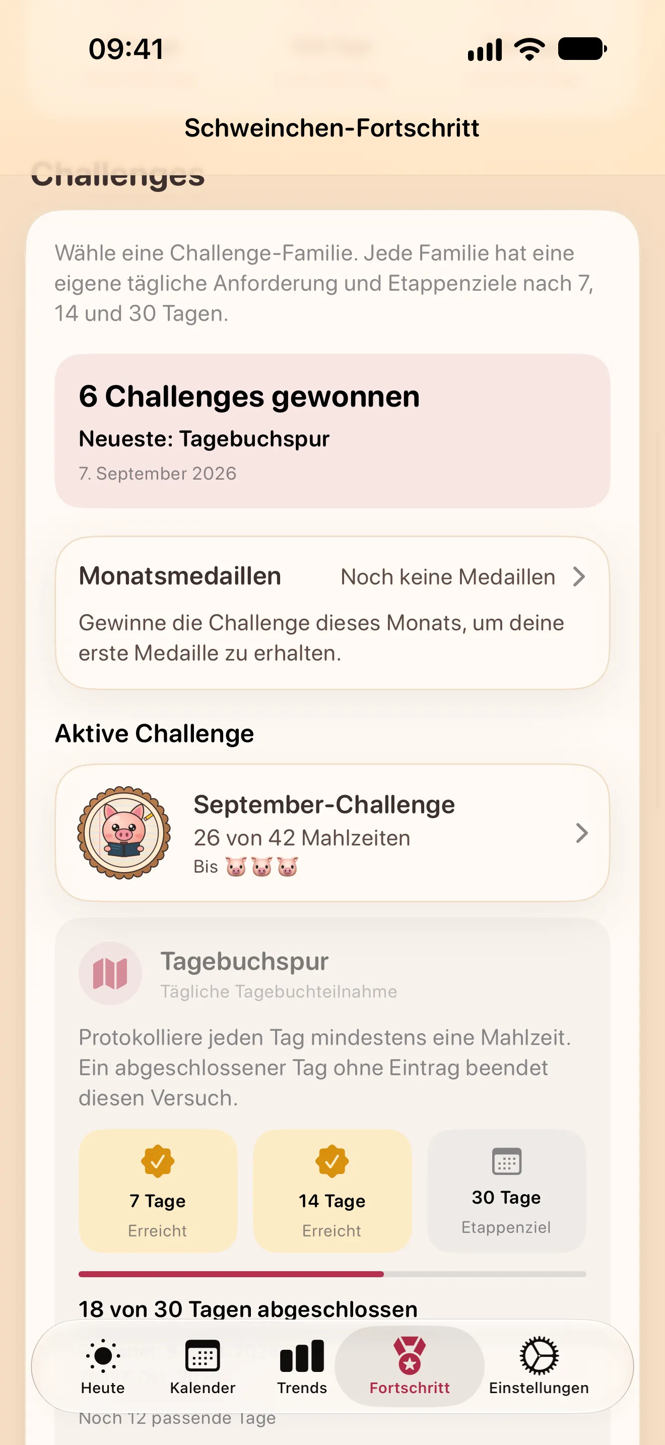 Der Fortschritt-Bildschirm: gewonnene Challenges, die Monatsmedaillen, die Challenge dieses Monats und eine aktive Challenge „Tagebuchspur“ mit ihren Etappenzielen
